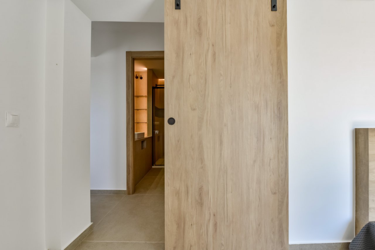 Moderner Eingangsbereich mit eleganter Schiebetür und integriertem Garderobensystem Moderner Eingangsbereich mit eleganter Schiebetür und integriertem Garderobensystem
