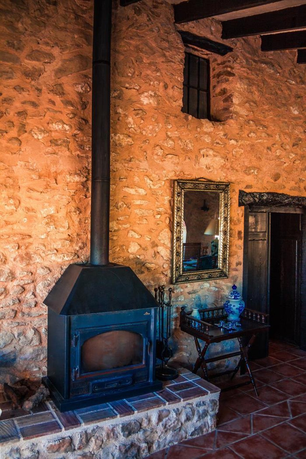 Rustic warmth: Cozy fireplace with natural stone walls - your refuge for chilly days Rustic warmth: Cozy fireplace with natural stone walls - your refuge for chilly days