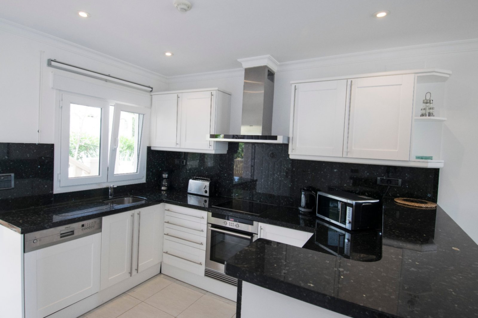 Exclusive designer kitchen with elegant granite countertop and state-of-the-art built-in appliances. Exclusive designer kitchen with elegant granite countertop and state-of-the-art built-in appliances.