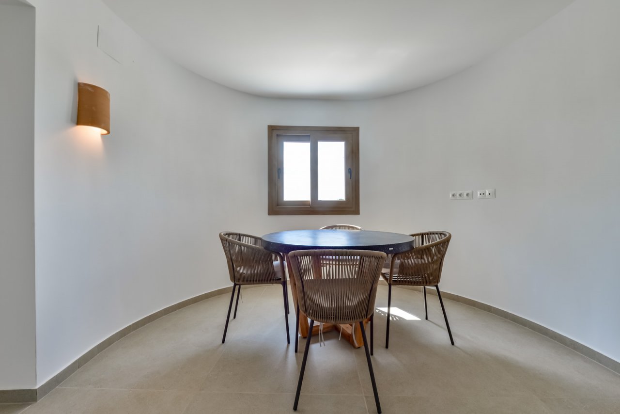 Brightly lit dining area with elegant design and harmonious layout Brightly lit dining area with elegant design and harmonious layout