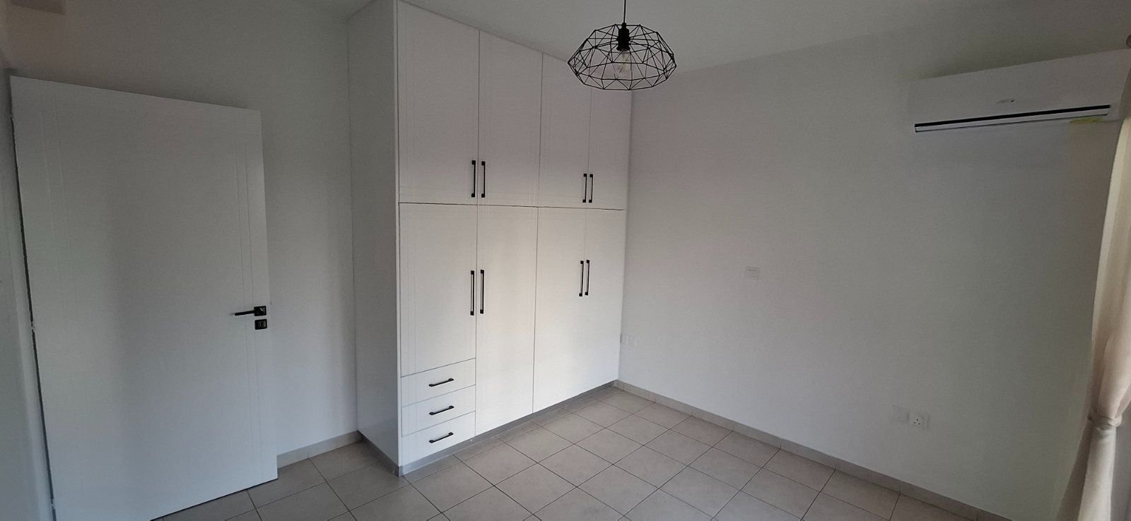 For sale is a well-maintained one-bedroom, one-bathroom apartment in Geroskipou. This resale property is situated on the top floor of a charming block